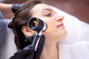Woman having her skin cancer screening at the dermatologist