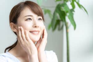 Woman admires her own radiant skin following chemical peel treatment in Sarasota.