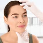 Patient at dermatology office has her skin examined by a trusted doctor who is experienced in medical and cosmetic care.