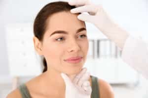 Patient at dermatology office has her skin examined by a trusted doctor who is experienced in medical and cosmetic care.