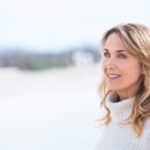 40-year-old woman near the shore has smooth refreshed skin with laser skin resurfacing.