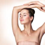 Woman has smooth arms and armpits after laser hair removal.